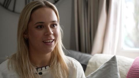 Endometriosis sufferer Pheobe Lewis, smiles at camera mid sentence. 