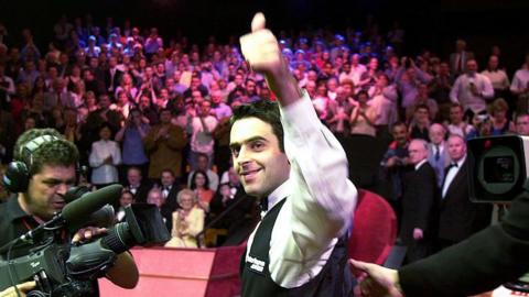 Ronnie O'Sullivan smiles and celebrates with a thumbs-up gesture after winning the 2001 World Championship