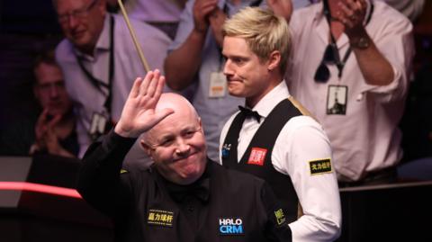 John Higgins celebrates