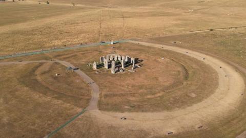 Stonehenge is surrounded by yellow grassland