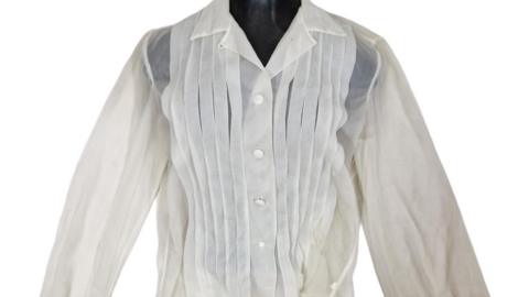 A image of a delicate white blouse that belonged to the actress Marilyn Monroe