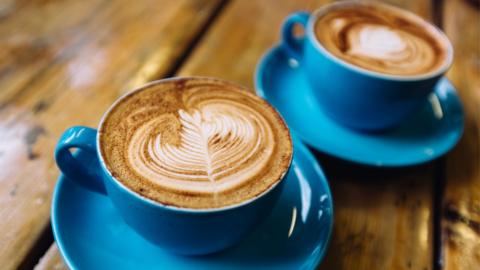 Two coffee cups on a table.