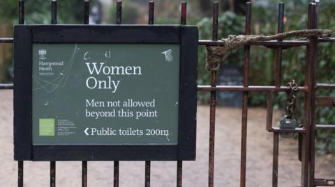 A sign indicating the 'Women Only, Men not allowed beyond this point' is seen attached to gates 