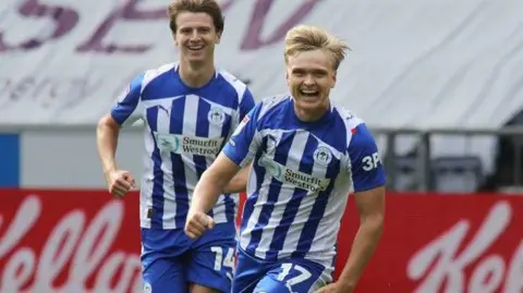 Wigan's Matt Smith right celebrates scoring during the League One match against Doncaster Rovers in September 2025