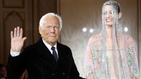Giorgio Armani with a model