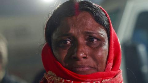 A pilgrim weeps outside the hospital after a stampede during Maha Kumbh Mela festival in Prayagraj on January 29, 2025. 