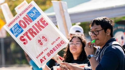 Striking workers picket outside Boeing factory in Renton, Washington.