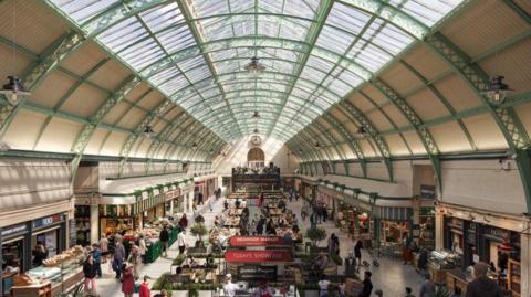 How Grainger Market would look from the top of the Nun Street pavilion looking down the arcade towards the Nelson Street pavilion. A range of stall selling plant, fruit and veg are visible, as well as cafes and bakeries.