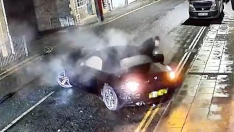 A BMW crashed into the side of a house