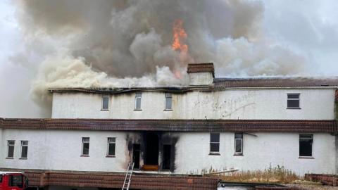 Flames coming from the roof of the hotel