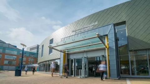 Entrance to University Hospital Southampton with a large curved facade and large windows 