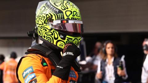 McLaren's Lando Norris clenches his right fist in celebration after taking pole position for the Sao Paulo Grand Prix sprint race