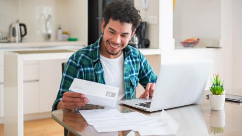 A man looks happy while looking at this bills