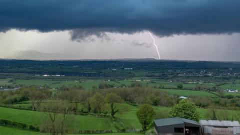 Menacing cloud with lightning in the distance in Northern Ireland
