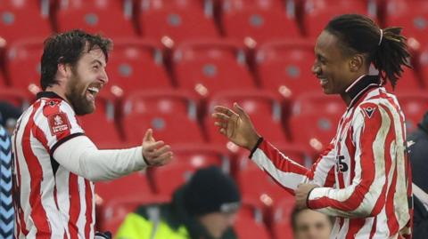 Lamine Cisse of Stoke City celebrates