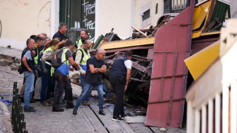 Police investigate the Gloria funicular wreckage one day after the accident that killed 15 in Lisbon, on September 4, 2025.