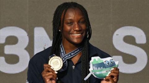 Desharne Bent-Ashmeil holds her gold medal