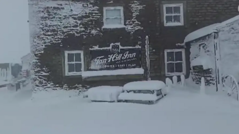 The Tan Hill Inn pub covered in snow 