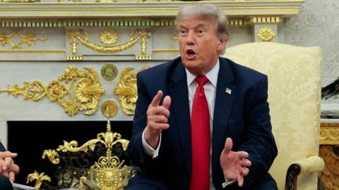 US president Donald Trump speaks with reporters in the Oval Office of the White House