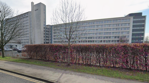 A large white office block from street view.
