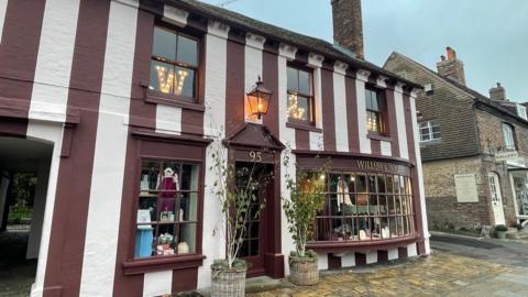 The stripey burgundy and pink exterior of Willow & Wolf in Marlborough.