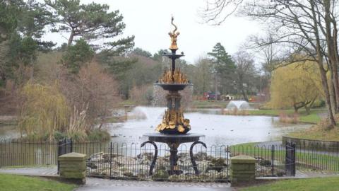 An ornate fountain by a lake in Hesketh Park