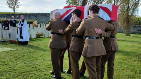 The coffin of Rifleman Adams is carried to his grave by serving soldiers of 3rd Battalion The Rifles