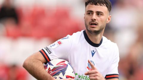 Aaron Collins celebrates a goal for Bolton
