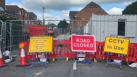 Roadwork barriers block a street in Godstone High Street