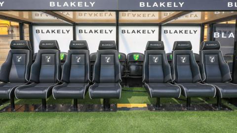 The empty home dugout inside Carrow Road