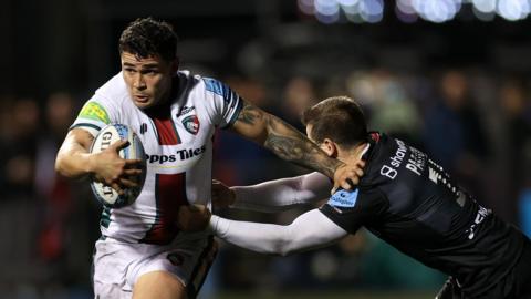 Leicester Tigers centre Izaia Perese holds off Saracens player Tom Parton