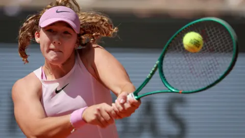 Mirra Andreeva hits a backhand