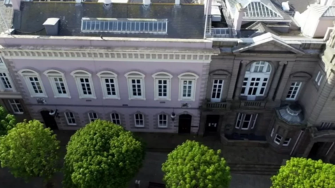 An aerial view of the government building in Jersey, which is painted pink.