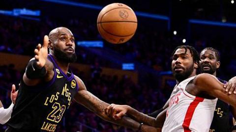 LeBron James reaching for the ball while playing for the Los Angeles Lakers against the Houston Rockets in game two of their 2026 NBA play-off series