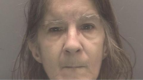 Gillian Shaw has white eyebrows and greying brown hair.