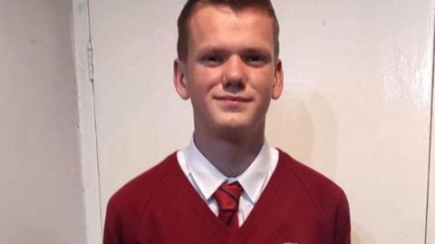 A photograph of Alex Crook in school uniform