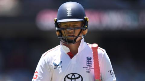 Ollie Pope looks dejected, with his bat under his arm