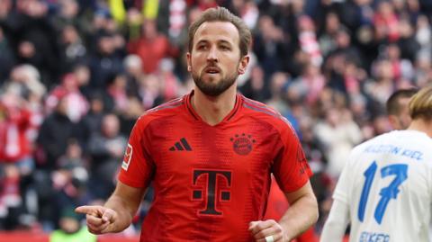 Harry Kane celebrates scoring against Holstein Kiel