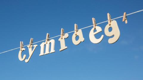 Cymraeg spelled out in letters hanging by pegs from a washing line