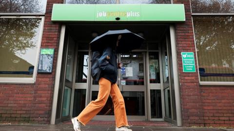 Woman walking past job centre