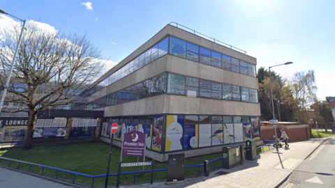 The exterior of the Charles Darwin school. It's a 1960s office building.