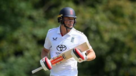 Ben McKinney batting for England Lions, with England helmet and England kit on