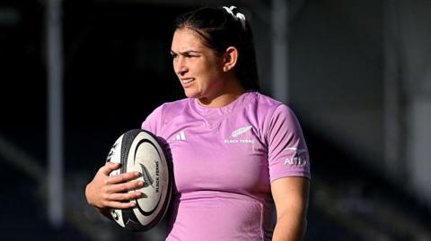 Georgia Ponsoby holds a ball in one hand while standing during a training session