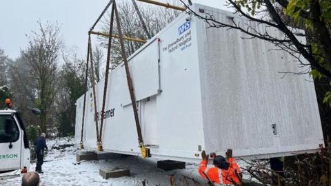 The new MRI scanner being lowered into position