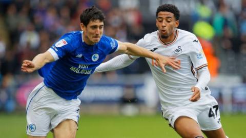 Cardiff City left-back Callum O'Dowda (L) challenges Swansea City midfielder Azeem Abdulai