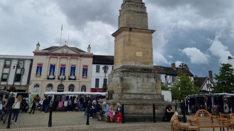 Ripon market place featuring large Georgian buildings surrounding the square with a number of stalls set up for market day