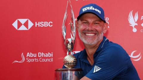 Paul Waring hugs the Abu Dhabi Championship trophy