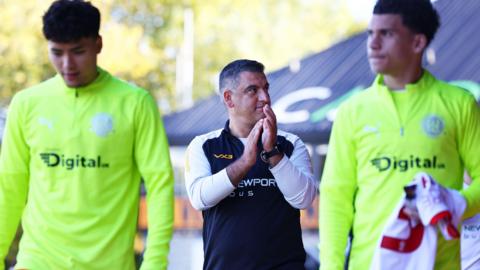 Nelson Jardim, head coach of Newport County, applauds the fans prior to a match 