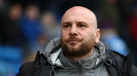 Fleetwood Town boss Matt Lawlor looks on