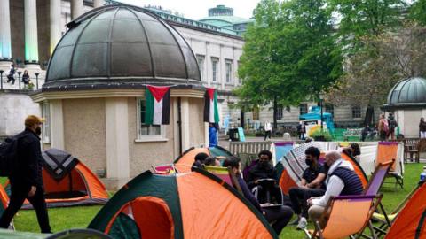 Protesters sitting outside tents in UCL Main Quad 